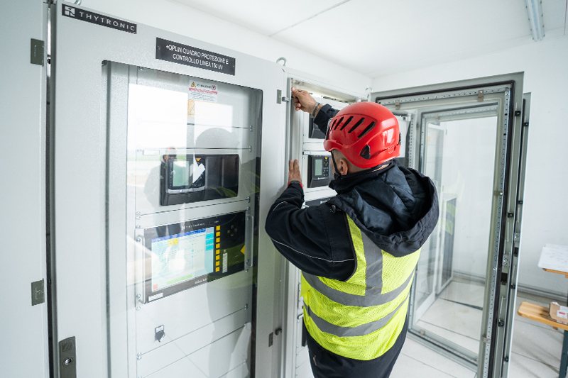 Technician working on an HV/MV automation panel